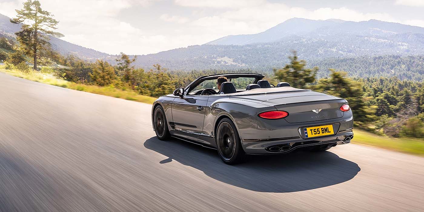Bentley Barcelona Bentley Continental GTC S convertible in Cambrian Grey paint rear 34 dynamic driving