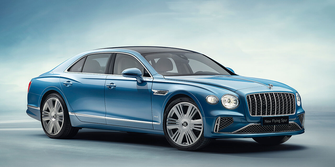 Bentley Barcelona New Bentley Flying Spur Azure sedan front view in Light windsor blue by Mulliner paint with 22 inch Azure wheels and chrome exterior details