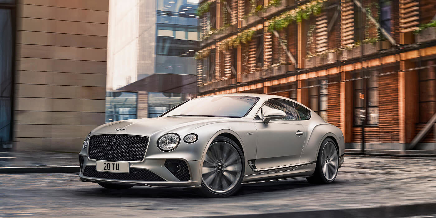 <new-bentley-continental-gt-speed-in-satin-silver-by-mulliner-paint-driving-in-manchester>
