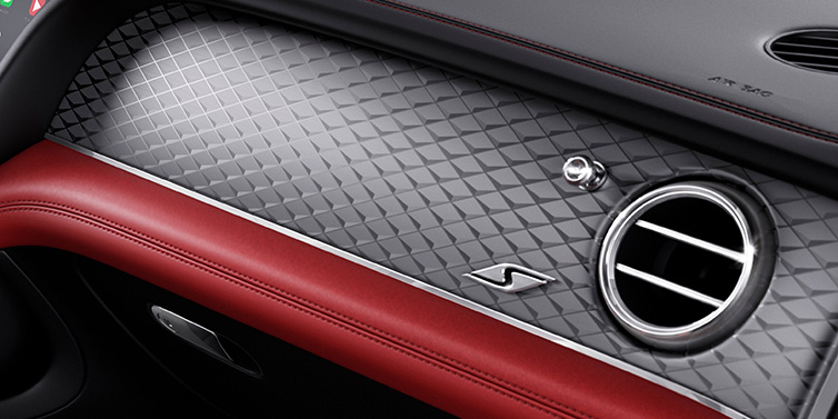 Bentley Barcelona Bentley Bentayga S SUV front interior dash with Dark Tint Diamond Brushed Aluminium veneer and S badge surrounded by Hotspur red and Beluga black hide