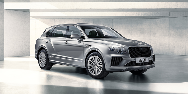 Bentley Barcelona Bentley Bentayga Extended Wheelbase SUV front three quarter in Moonbeam paint with a grey background