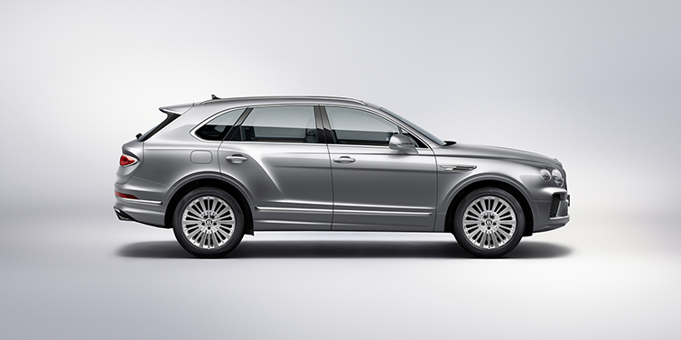 Bentley Barcelona Bentley Bentayga SUV side profile in Moonbeam silver paint against white background featuring 21 inch 5 spoke wheels