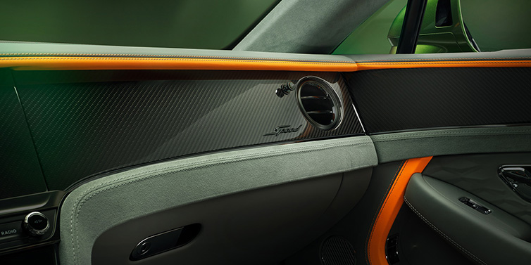 Bentley Barcelona Bentley Continental GT Speed coupe front interior dash detail with high gloss carbon fibre veneer surrounded by Mandarin by Mulliner and Gravity Grey hides