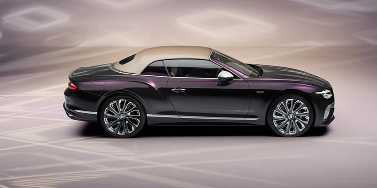 Bentley Barcelona Bentley Continental GTC Mulliner convertible in profile with hood up, in Tanzanite Purple paint and 22 inch Mulliner painted and polished wheels