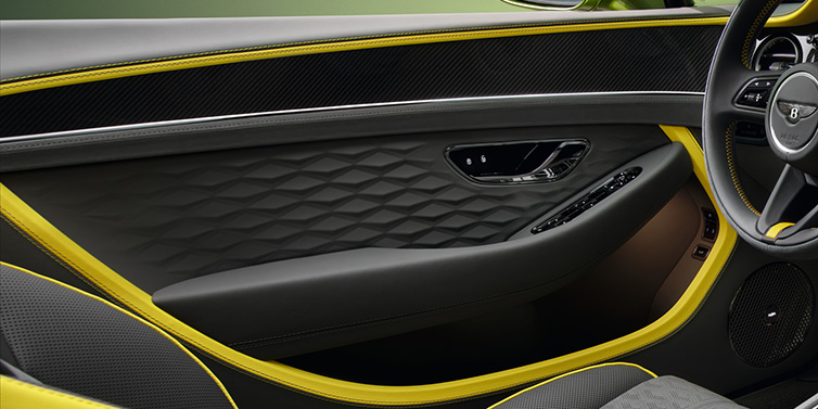 Bentley Barcelona Bentley Continental GTC Speed convertible interior door details featuring Gravity Grey and Cyber Yellow by Mulliner hides and high gloss carbon fibre veneer