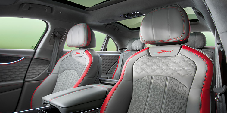 Bentley Barcelona Bentley Flying Spur Speed sedan interior showing front and rear seats in Hotspur red and Gravity Grey hides, with Speed seat emblems