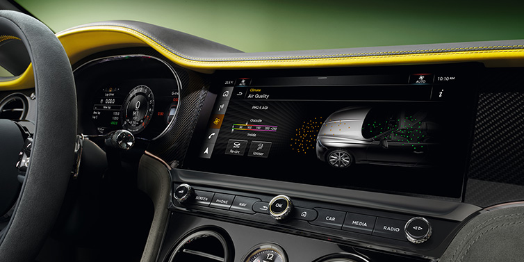 Bentley Barcelona Bentley Continental GTC Speed convertible front interior centre console with MMI screen showing Air Quality visualisation surrounded by Cyber Yellow by Mulliner and Gravity Grey hides and high gloss carbon fibre veneer